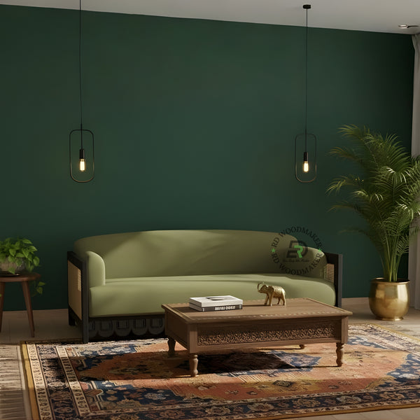 OLIVE GREEN SOFA WITH SCALLOPED BLACK FRAME AND CANE SIDES